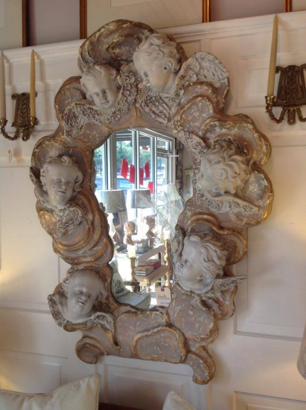 we love the weird too...this cherub head mirror may be creepy to some but not our french girl...