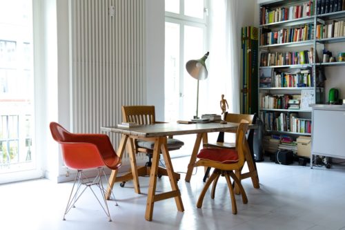 modern eating dining area with bookshevles